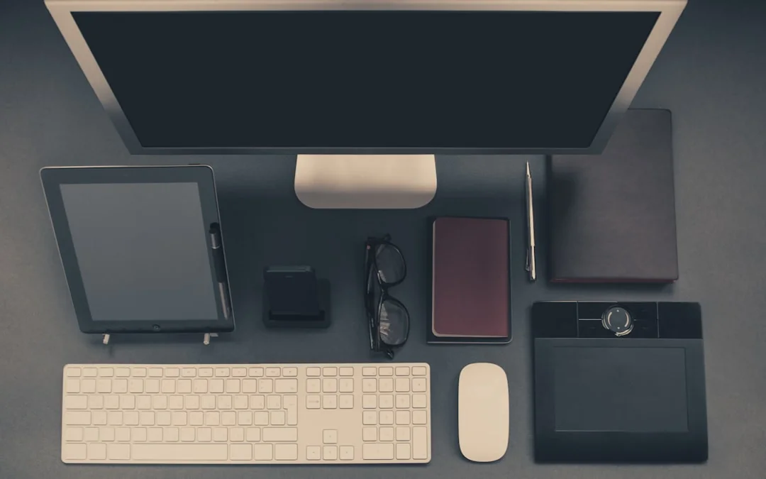 A stylish workspace featuring a laptop and monitors displaying design software.